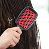 Model using UNbrush Detangling Hair Brush in Canyon Red in wet hair