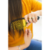 Model using UNbrush Detangling Hair Brush in Sunburst Yellow