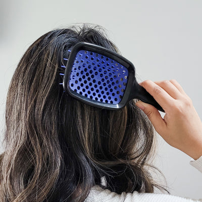 Model using the UNbrush Detangling Hair Brush in Galaxy Dark Blue in hair