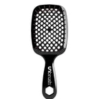Black Unbrush detangling brush with black hexagon bristle pattern, designed for gentle use on wet or dry hair.