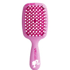 Pink hairbrush with character design on a white background