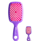 Purple and pink hairbrush with matching keychain on a white background